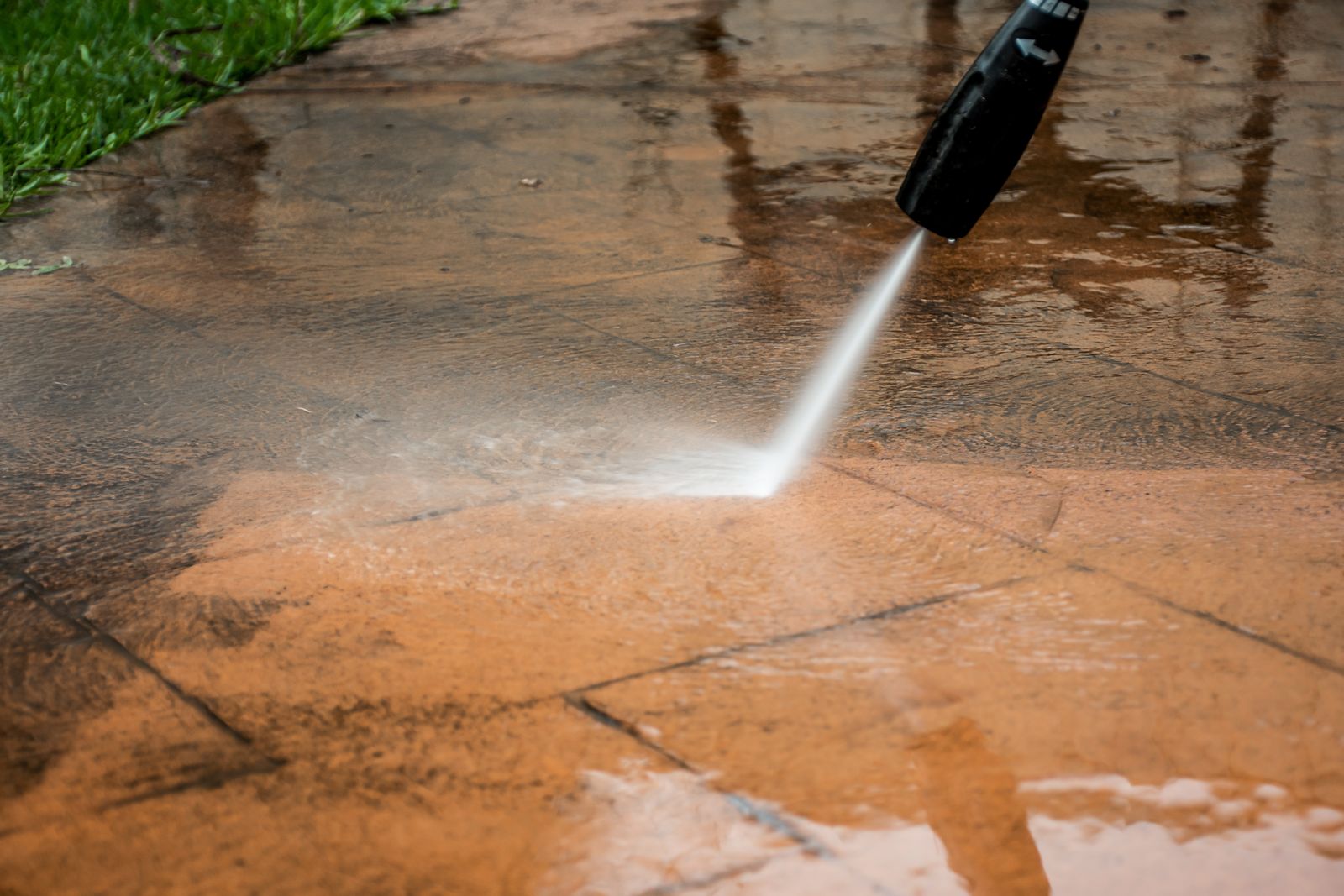 Pressure washing a backyard patio surface in Richmond, VA