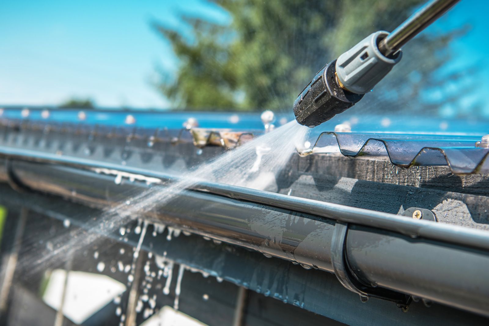Exterior gutter line being rinsed clean